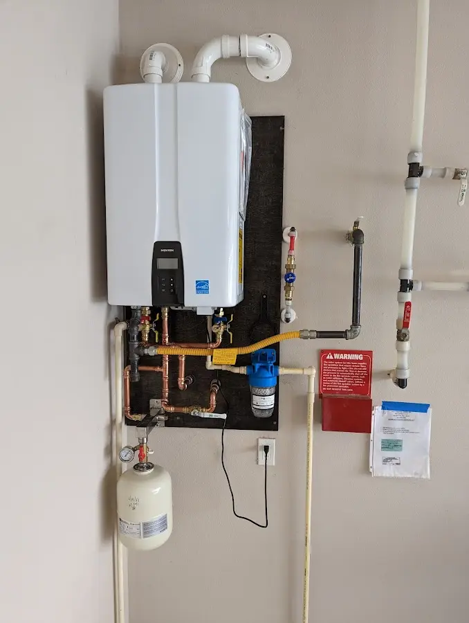 Professional plumber installing copper piping in a Keller home